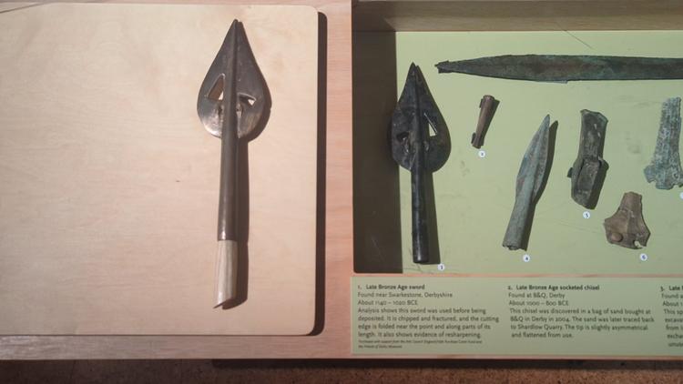 Bronze cast spear replica with original on museum display